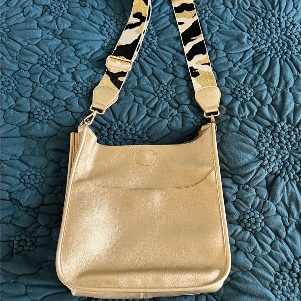 Ah-dorned gold messenger bag with strap
